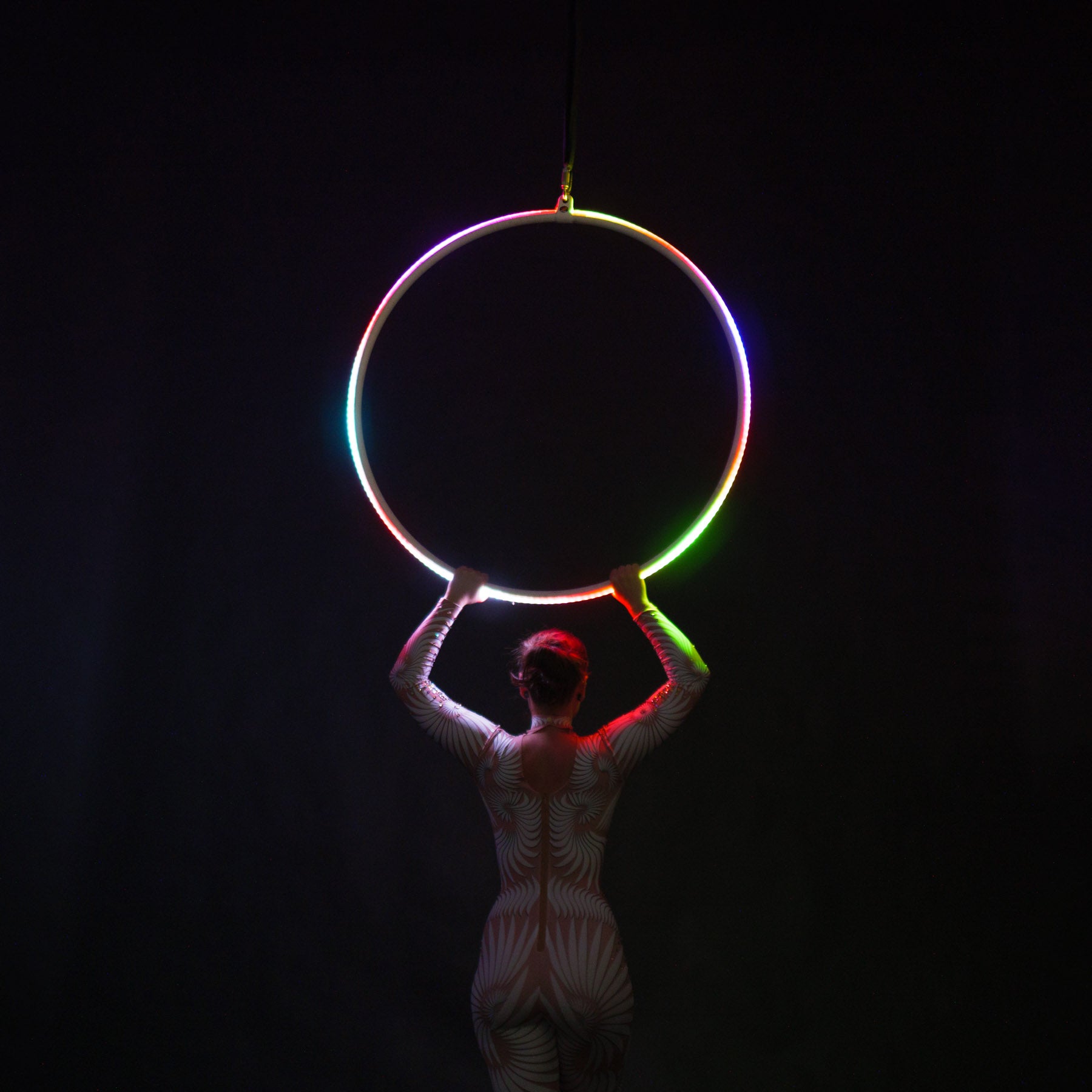 Hoop glowing illuminating subject holding the hoop