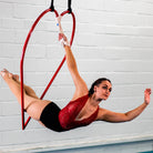 performer in aerial heart hoop using a hand loop strap